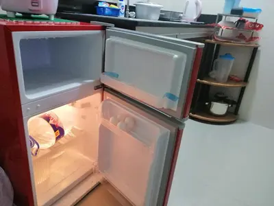 an empty refrigerator with its door open in a kitchen at Condo Near NAIA Airport T 1,2,3&4 v4 in Manila