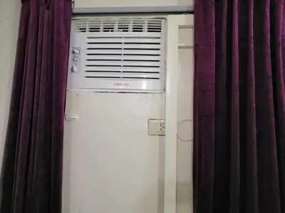 a air conditioner in a room next to a window at Condo Near NAIA Airport T 1,2,3&4 v4 in Manila