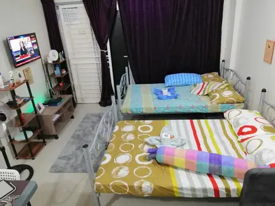 a bedroom with two beds and a tv at Condo Near NAIA Airport T 1,2,3&4 v4 in Manila