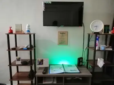 a room with a table with a television on a wall at Condo Near NAIA Airport T 1,2,3&4 v4 in Manila
