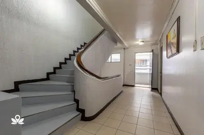 a hallway with a staircase in a building at Victoria Mansions in Manila