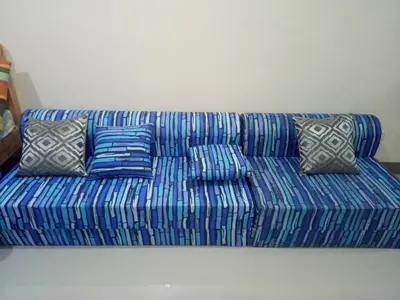 a blue couch with pillows sitting in a room at Kassel residence Mhavic Family room good for 5guest in Manila