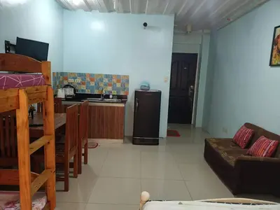 a kitchen and living room with a couch and a refrigerator at Kassel residence Mhavic Family room good for 5guest in Manila