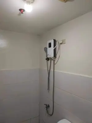 a shower in a bathroom with a toilet and a shower head at Kassel residence Mhavic Family room good for 5guest in Manila