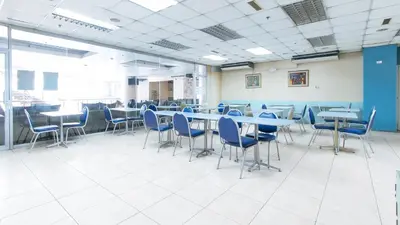 a large room with tables and chairs in it at RedDoorz Plus @ E Rodriguez Corner Banawe in Manila