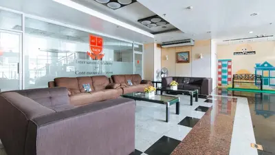 a living room with two couches and a table at RedDoorz Plus @ E Rodriguez Corner Banawe in Manila