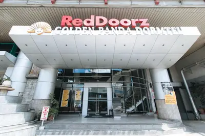 a red door colombianian bank building with a sign on it at RedDoorz Plus @ E Rodriguez Corner Banawe in Manila