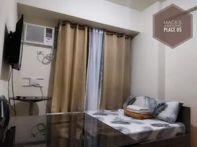 a room with a bed and a window with curtains at Macks Awesome Place 05 with Netflix and FastUnliwifi in Manila