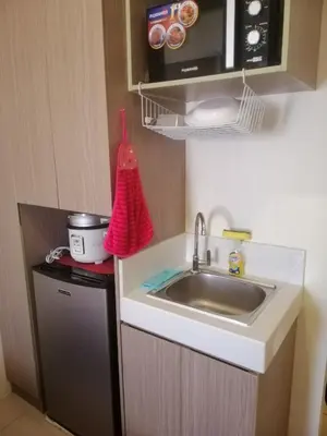 a kitchen with a sink and a microwave at Macks Awesome Place 05 with Netflix and FastUnliwifi in Manila