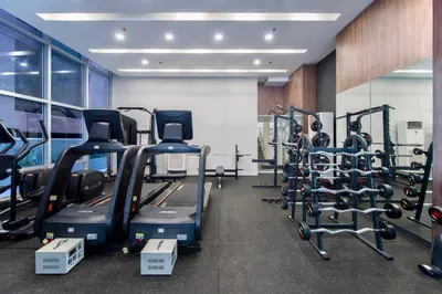 a gym with treadmills and elliptical machines at The Sphere Serviced Residences Managed by HII in Manila