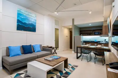 a living room with a couch and a table at The Sphere Serviced Residences Managed by HII in Manila