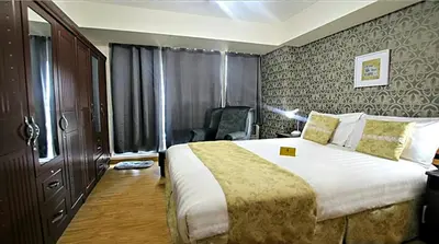 a hotel room with a large bed and a chair at AZURE C5 MAN-MADE BEACH BALCONY Multiple Units in Manila