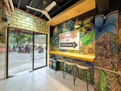 a bar with a sign on the wall of a restaurant at Dormitelsph UST in Manila