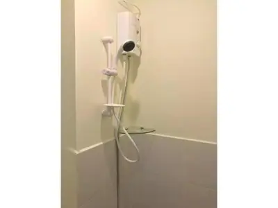a shower in a bathroom with a shower head at Shanilyn Residency Urban Deca Towers EDSA Mandaluyong,UNLIMITED INTERNET AND NETFLIX in Manila