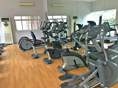 a gym with rows of treadmills and exercise bikes at Makati - Chino Roces Trevi Towers in Manila