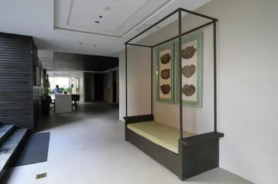 a hallway with a glass display case in a building at Makati - Chino Roces Trevi Towers in Manila