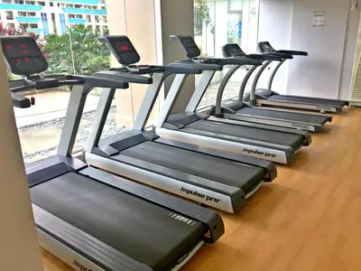 a row of treadmills in a row in a gym at Makati - Chino Roces Trevi Towers in Manila