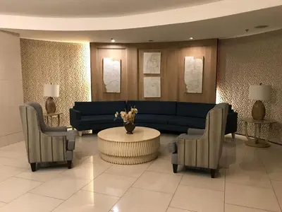 a living room with a blue couch and two chairs at Best Value Q Condo1439 in Manila