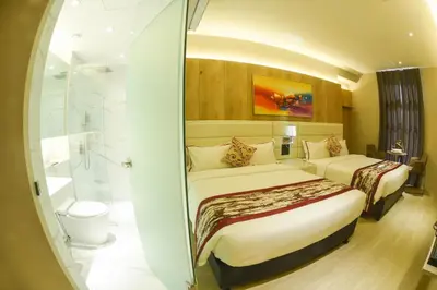 a hotel room with two beds and a shower at Red Hotel Cubao, Quezon City in Manila