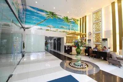a lobby with a vase of flowers on a table at Malate Bayview Mansion city view in Manila