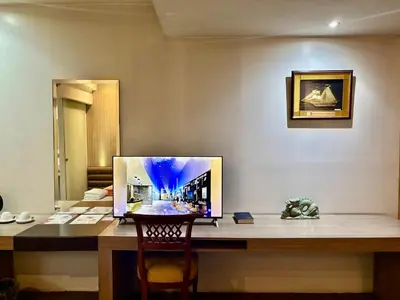 a desk in a room with a picture on the wall at The E-Hotel Makati in Manila