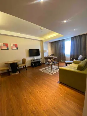 a living room with a couch and a table at ACE Hotel and Suites in Manila