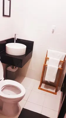 a bathroom with a toilet and a sink at Studio Fully Furnished in Manila