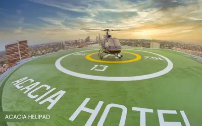 a helicopter sitting on top of a runway at Acacia Hotel Manila in Manila