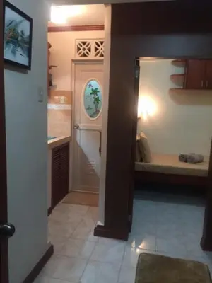 a hallway of a house with a kitchen and a bathroom at Las Pinas Serviced Apartment in Manila