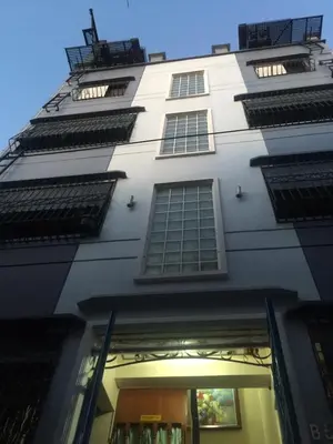 a tall white building with many windows on it at Las Pinas Serviced Apartment in Manila