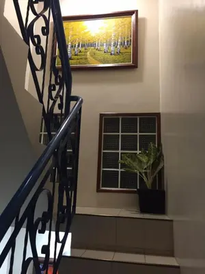 a staircase with a picture of a soccer game on the wall at Las Pinas Serviced Apartment in Manila