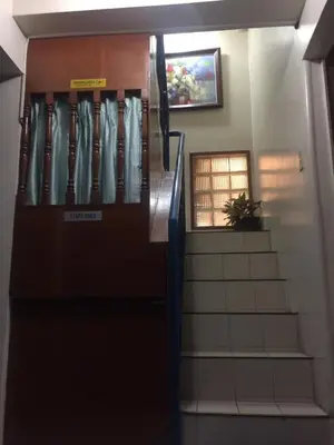 a stairway leading up to a building with a door at Las Pinas Serviced Apartment in Manila