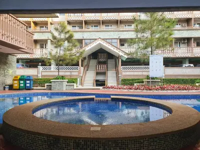 a large swimming pool in front of a building at SweetSuites at Pine Crest #T3-239 in Manila