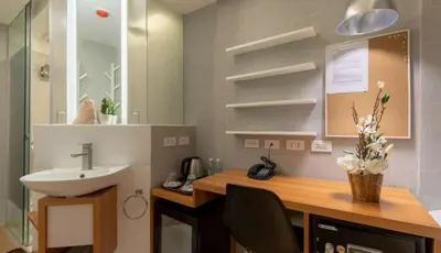 a bathroom with a sink and a counter with a sink at Selah Pods Hotel Manila in Manila