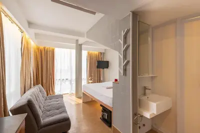 a hotel room with a bed and a sink at Selah Pods Hotel Manila in Manila