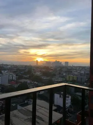 a view of a city at sunset from a building at A Home with a view, 1 Bdrm with balcony and Netflix Access in Manila