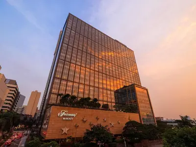 a tall building with a sign on the side of it at Fairmont Makati in Manila