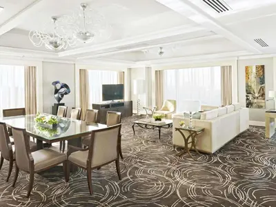 a living room with a dining table and a couch at Fairmont Makati in Manila
