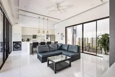a living room with a couch and a table at Addie's Place Soldiers Hills Village Muntinlupa in Manila
