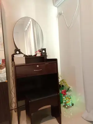 a mirror on top of a dresser in a room at Jen's Paranaque City Apartment in Manila