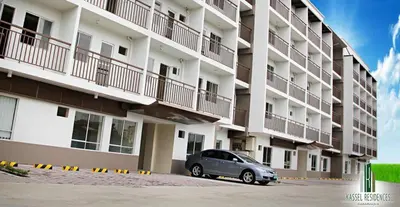 a car parked in front of a large apartment building at Jen's Paranaque City Apartment in Manila