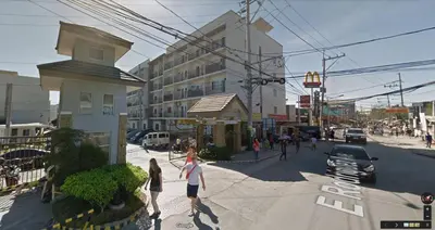 a rendering of a city with people crossing a street at Jen's Paranaque City Apartment in Manila
