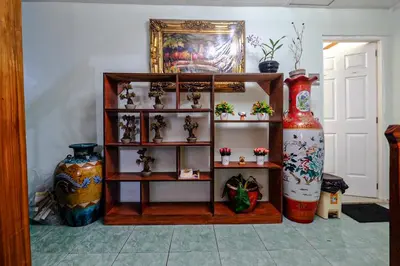 a room with vases and shelves with vases at Bing's Place in Manila