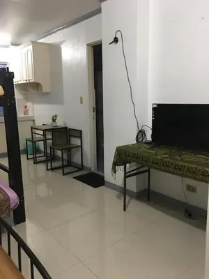 a living room with a table and a dining room at Bing's Place in Manila