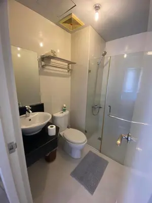 a bathroom with a shower and a toilet and a sink at Modern Studio Unit at One Palm Tree Villas near NAIA & Resortsworld in Manila