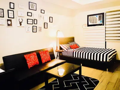 a living room with a couch and a table at The Sentinel Residences Suite in Manila