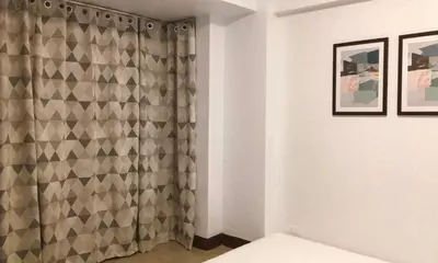 a bathroom with a shower curtain in a room at F-10C Parkside Villas in Manila