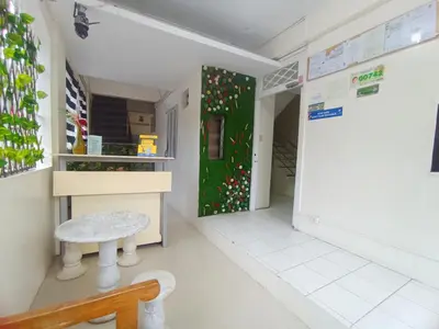 a room with a green door and a bench at Bed and Brewhouse Sucat in Manila