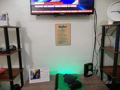 a room with a tv on the wall and a table at Condo Transient Near NAIA Airport-Unlimited Internet v2 in Manila