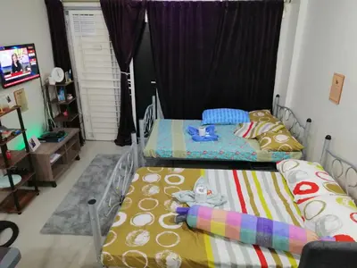 two twin beds in a room with a tv at Condo Transient Near NAIA Airport-Unlimited Internet v2 in Manila